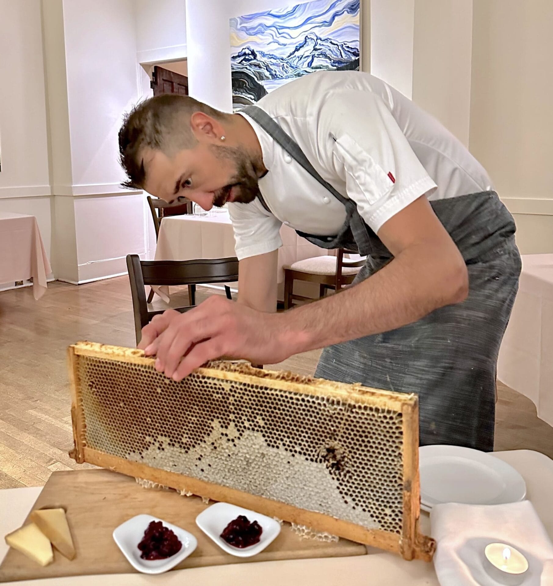 Dean Fast, Rouge’s chef de cuisine, preps the honey course for guests in the restaurant’s historic dining room