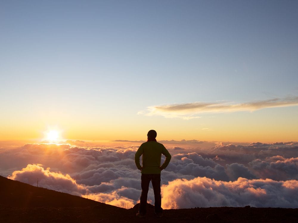 Admiring sunset above the clouds at the summit of Haleakala on Maui