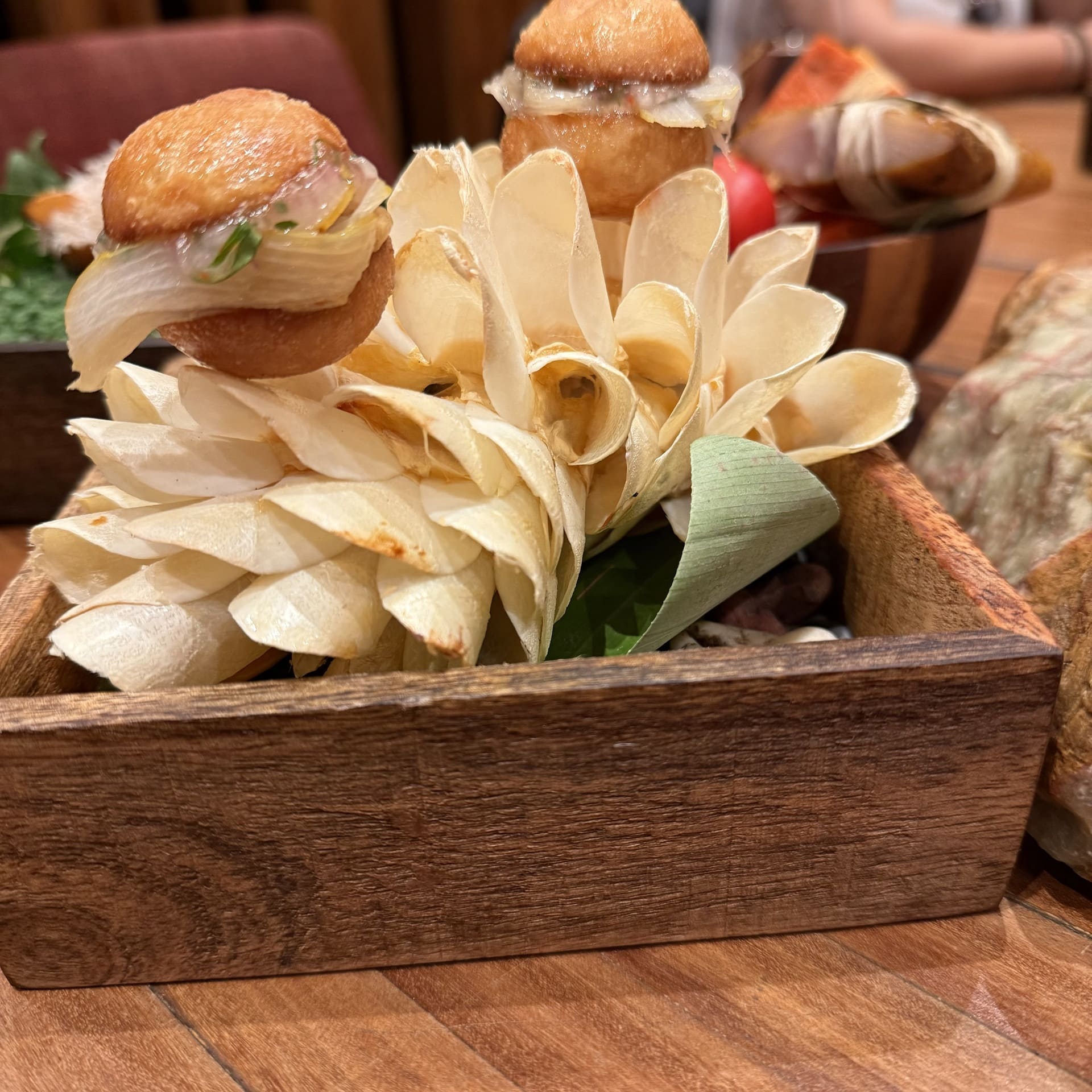 Paiche sandwiches are served on a stand of thumbnail-sized scales from the massive Amazonian river fish at Maido in Lima, Peru
