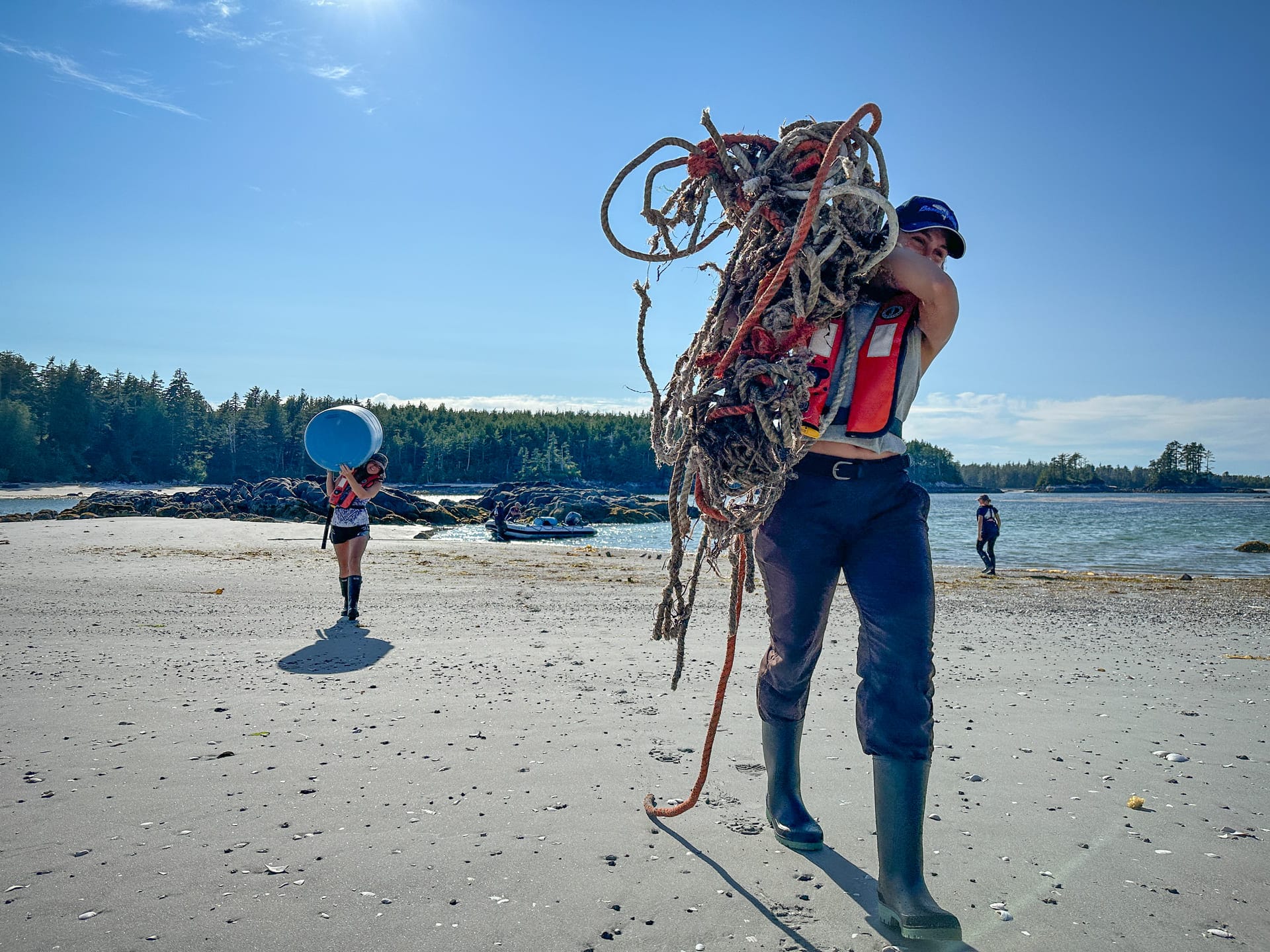Maple Leaf crew members help clean a beach as part of the Marine Debris Removal Initiative