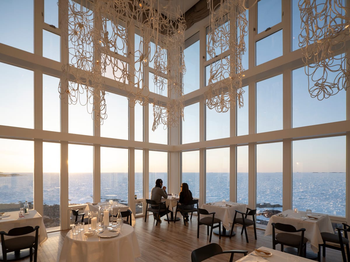 Fogo Island Inn Dining Room Couple at Table Sunset Fogo Island Inn Dining Room Couple at Table Sunset