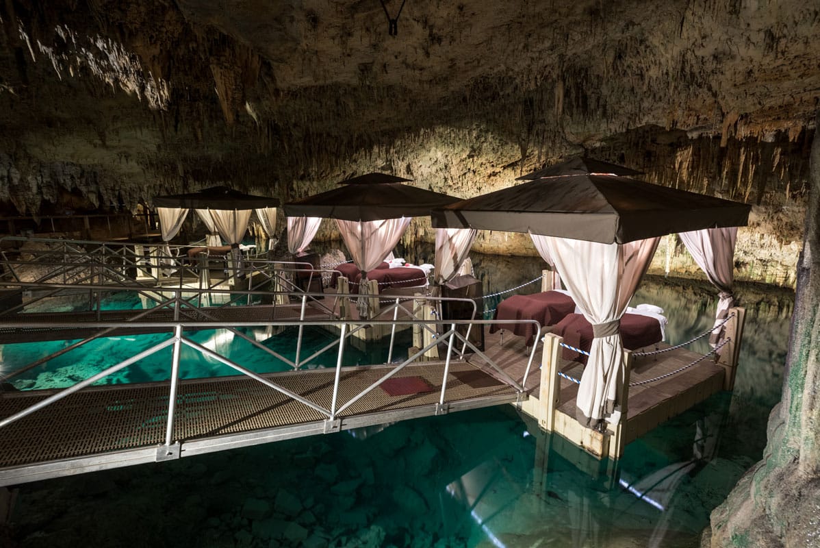The Natura Spa at the Grotto Bay Beach Resort is located in Prospero’s Cave, where massages are done on private floating pavilions