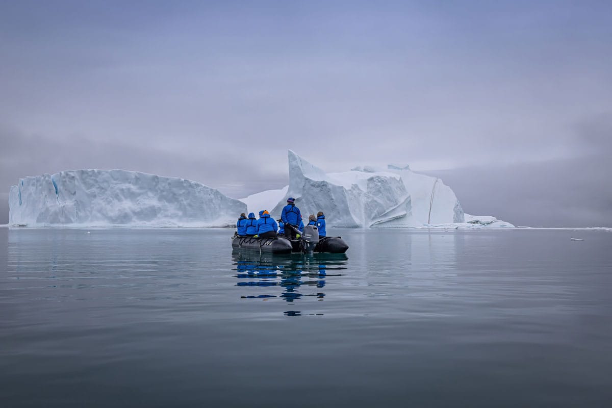 Ocean Endeavour passengers Zodiac boat, Arctic tourism, glacier cruise, iceberg, cold weather explore