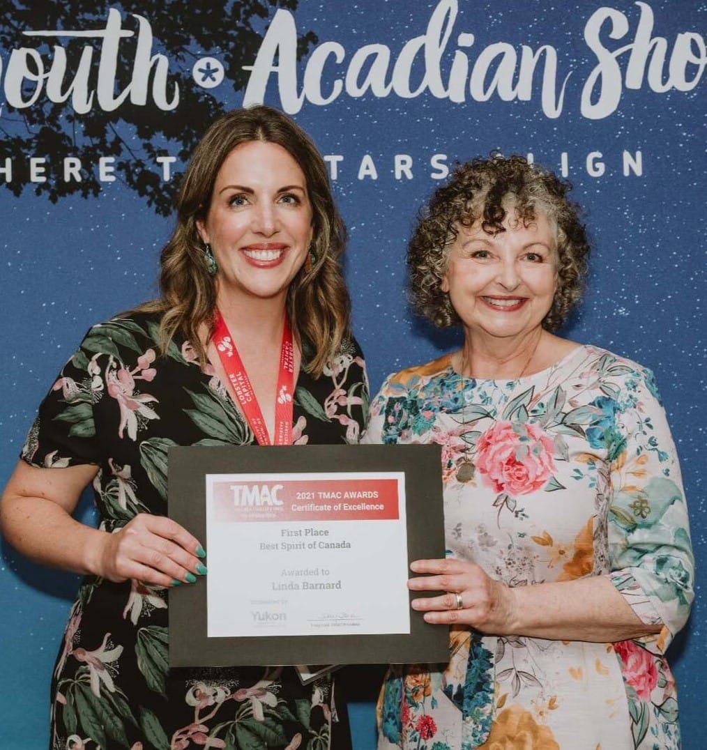 Linda Barnard – “Certificate of Excellence” from the 2021 TMAC Awards for “Best Spirit of Canada” Two women smile, holding a