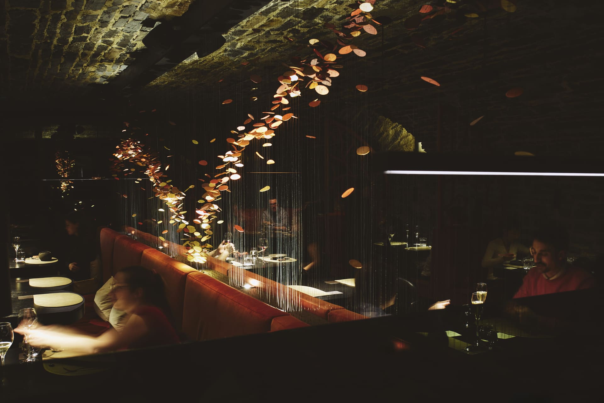 The dining room at Tanière³ is in one of four 17th-century underground vaults. A hanging sculpture that represents the St. Lawrence River.