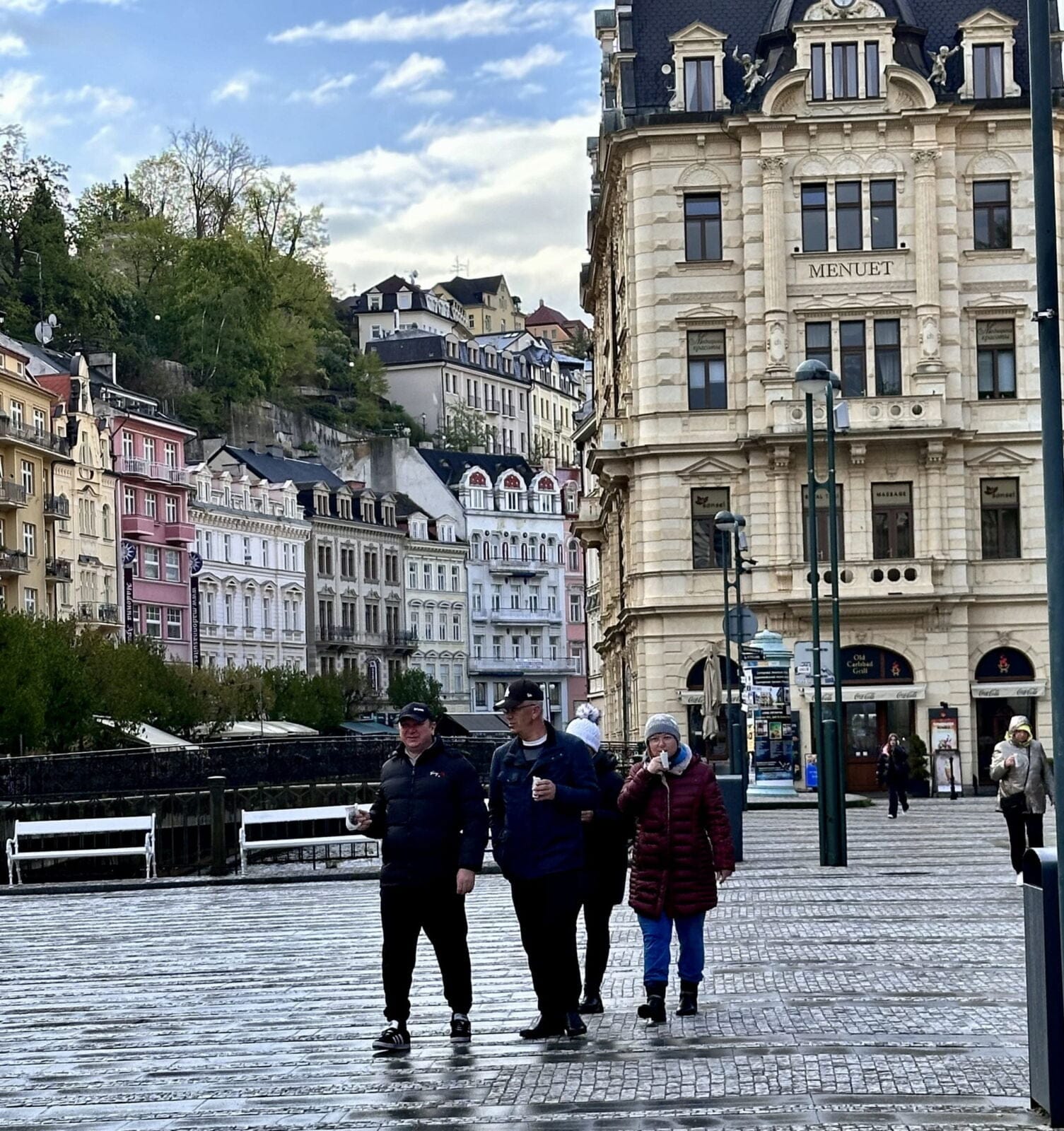 Each morning, visitors and locals sip hot mineral water from Karlovy Vary’s underground springs as they stroll. At top, in 2021, Karlovy Vary became part of the transnational UNESCO World Heritage Site under the name “Great Spa Towns of Europe” because of its spas and architecture from the 18th through 20th centuries