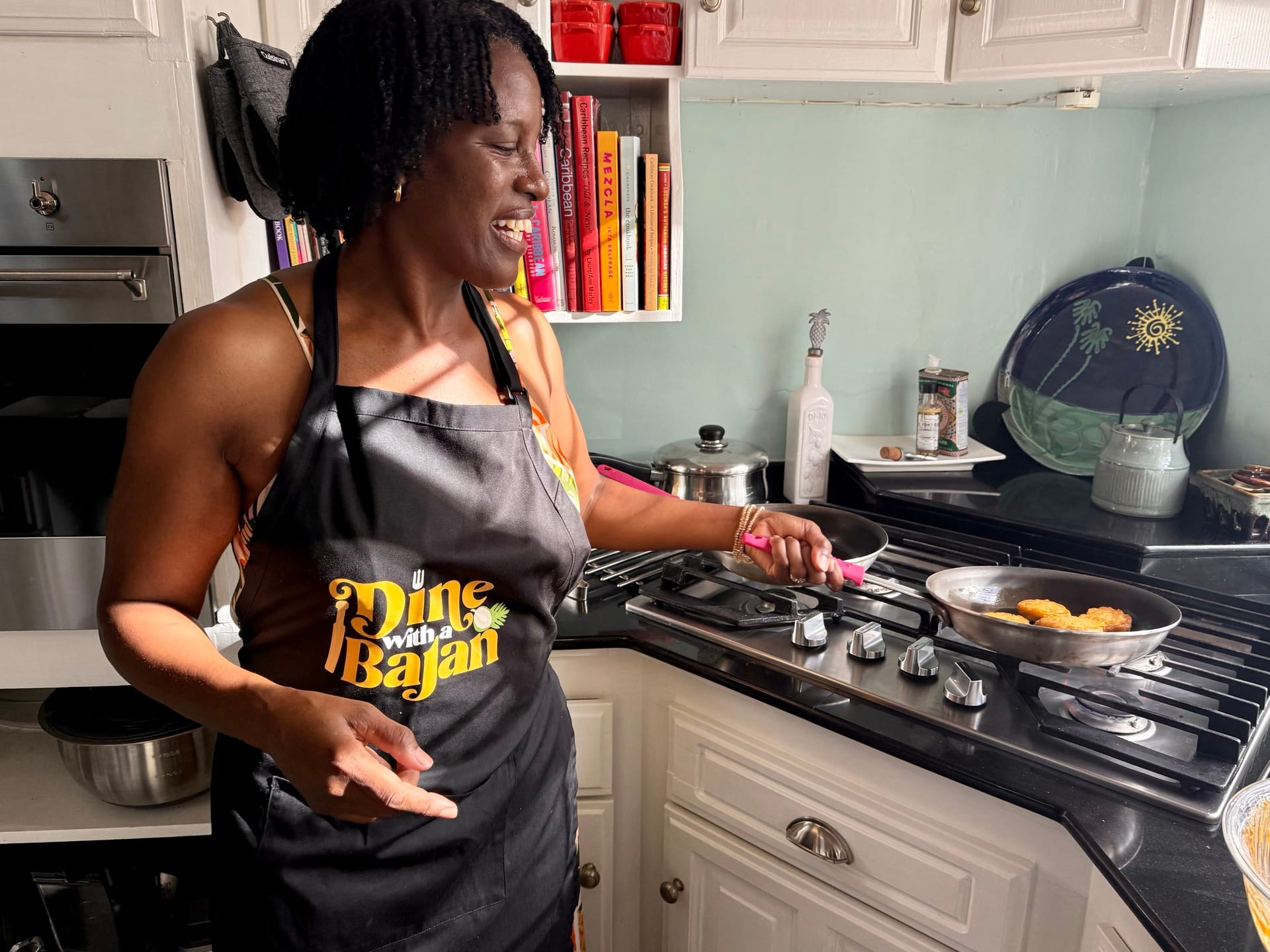 A woman makes fried pumpkin fritters on the stove.